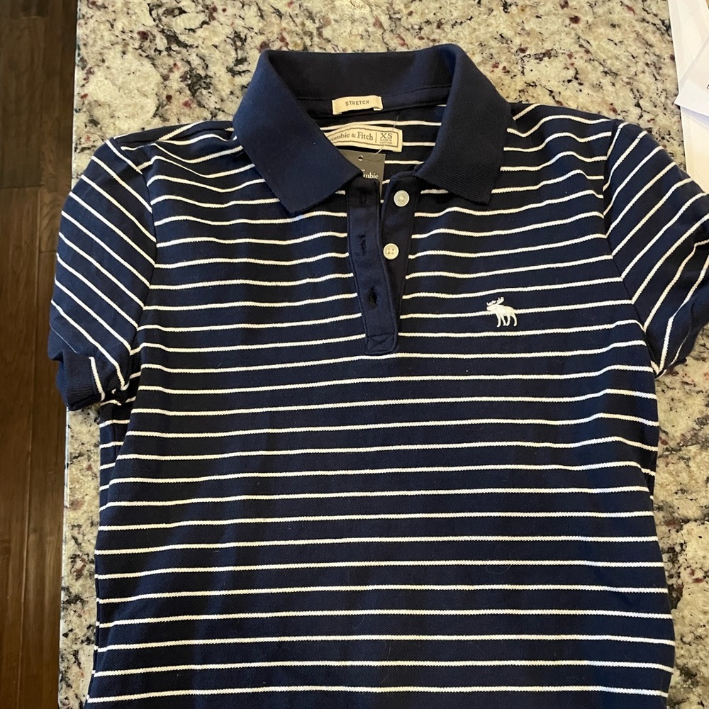 Abercrombie Women’s Navy and White stripe Polo.

Size xs